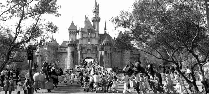 In this Sunday, July 17, 1955, file photo, children sprint across a drawbridge and into a castle that marks the entrance to Fantasyland at the opening of Walt Disney's Disneyland in Anaheim, Calif. Fantasyland had been closed until late in the day.